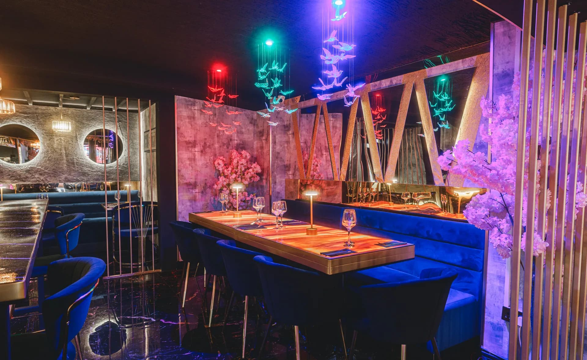 Blue velvet seating and colourful lighting inside Sweet1ne Live